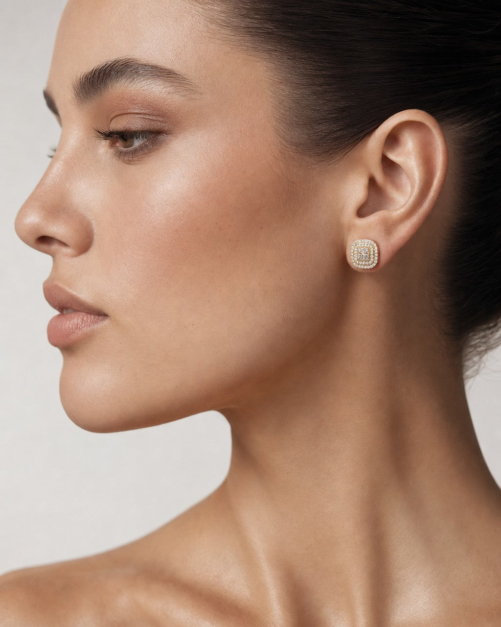 Female model wearing 14K 8.2MM Rounded Square Diamond Earrings