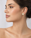 Female model wearing 14K 8MM Rounded Square Diamond Baguette Earrings