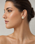 Female model wearing 14K 8.7MM Rounded Square Baguette Diamond Earrings