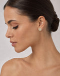 Female model wearing 14K 8MM Rounded Square Halo Diamond Earrings