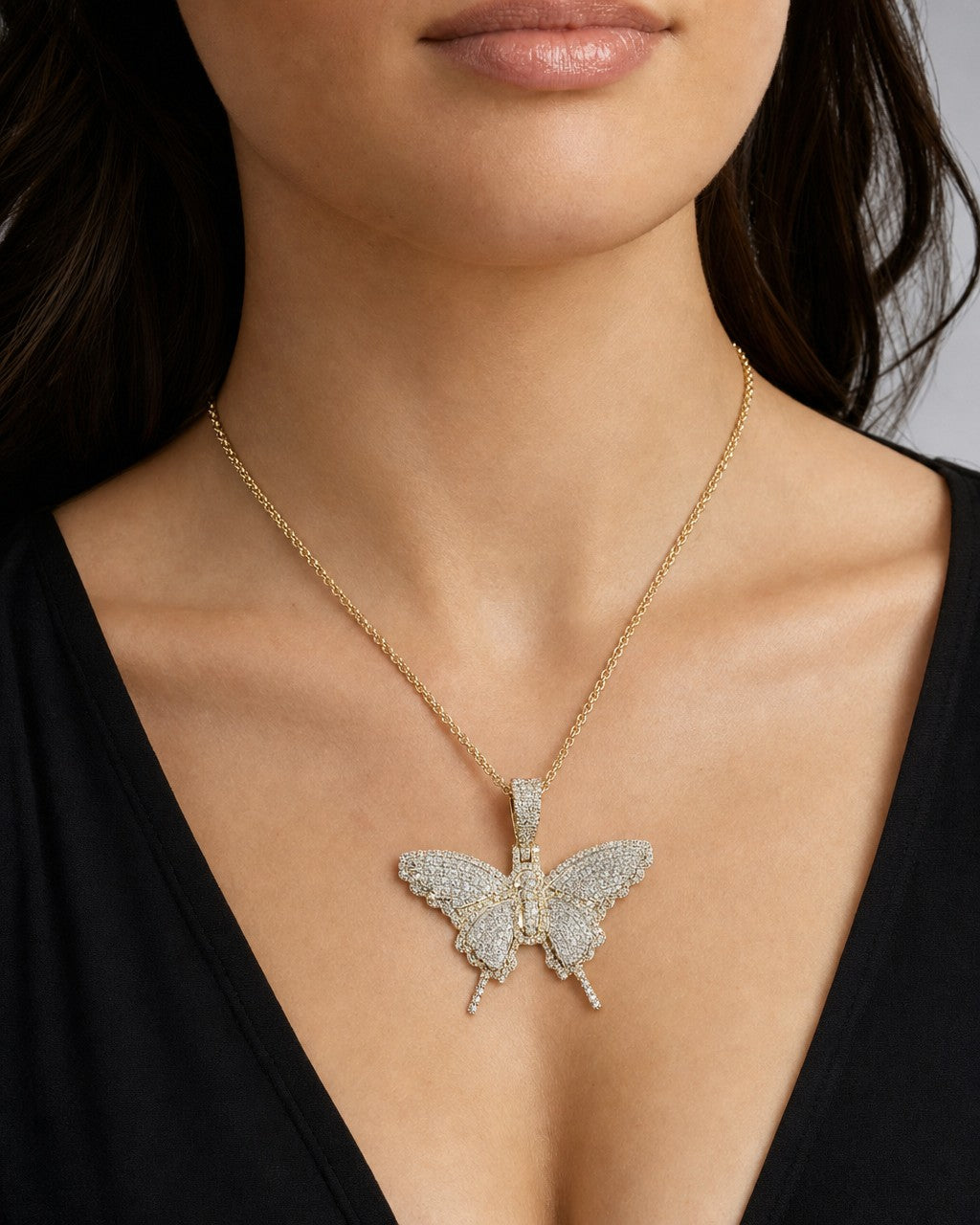 Female model wearing 14K Kali Butterfly Diamond Pendant