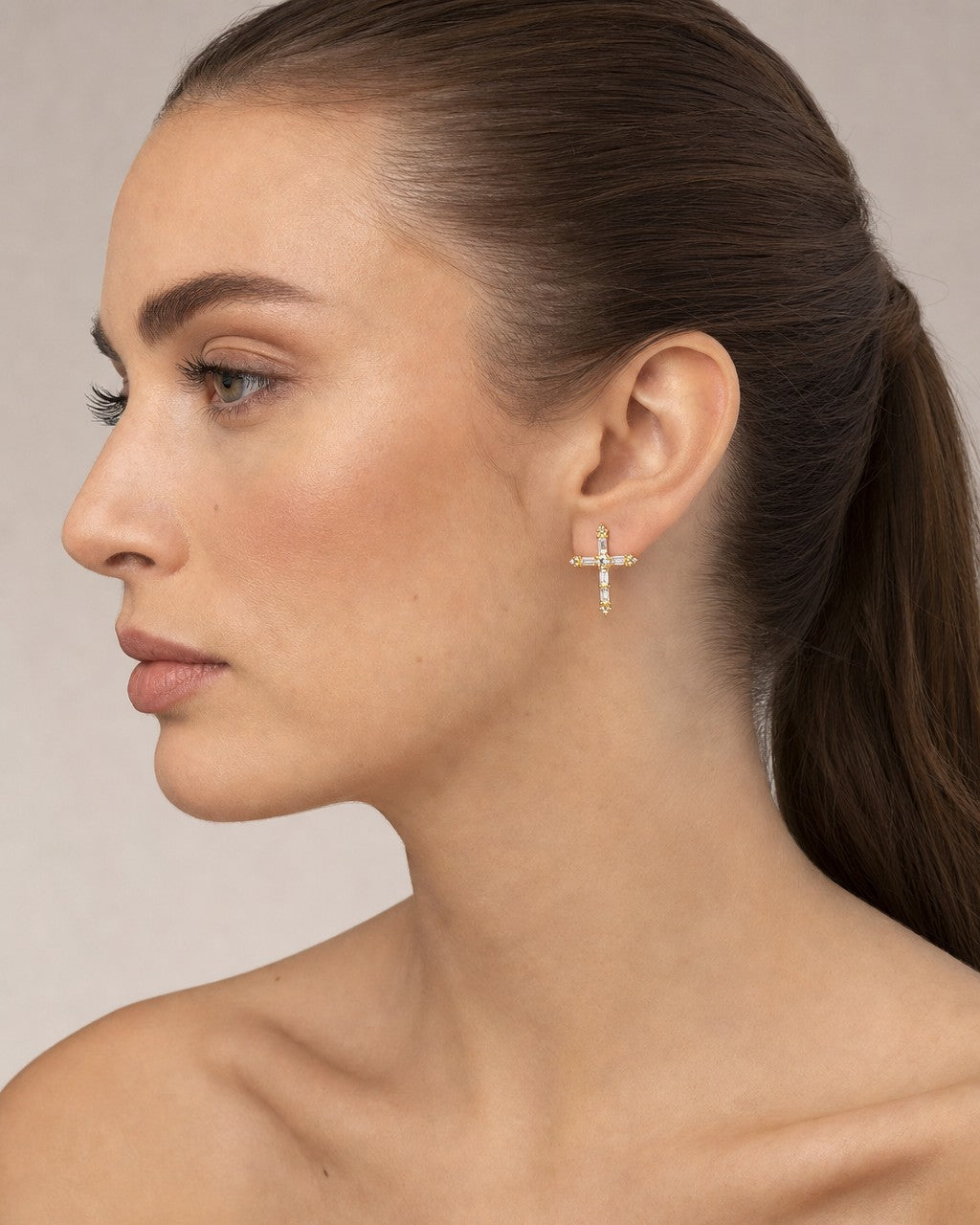 Female model wearing 14K Rosalia Cross Diamond Earrings