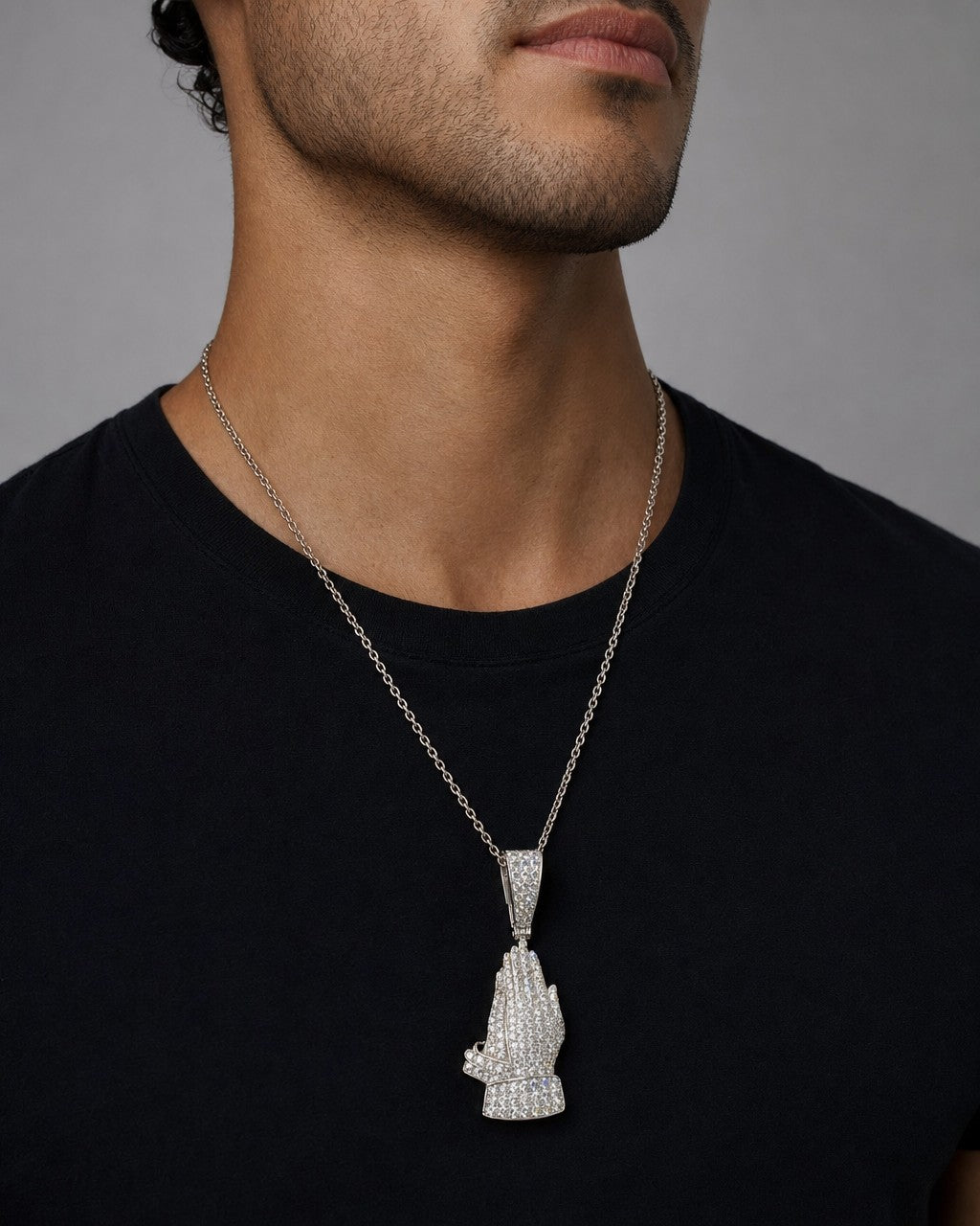 Male model wearing 10K Bless Up Praying Hands Diamond Pendant