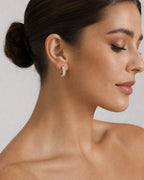 Female model wearing 14K Bold Diamond Baguette Hoop Earrings