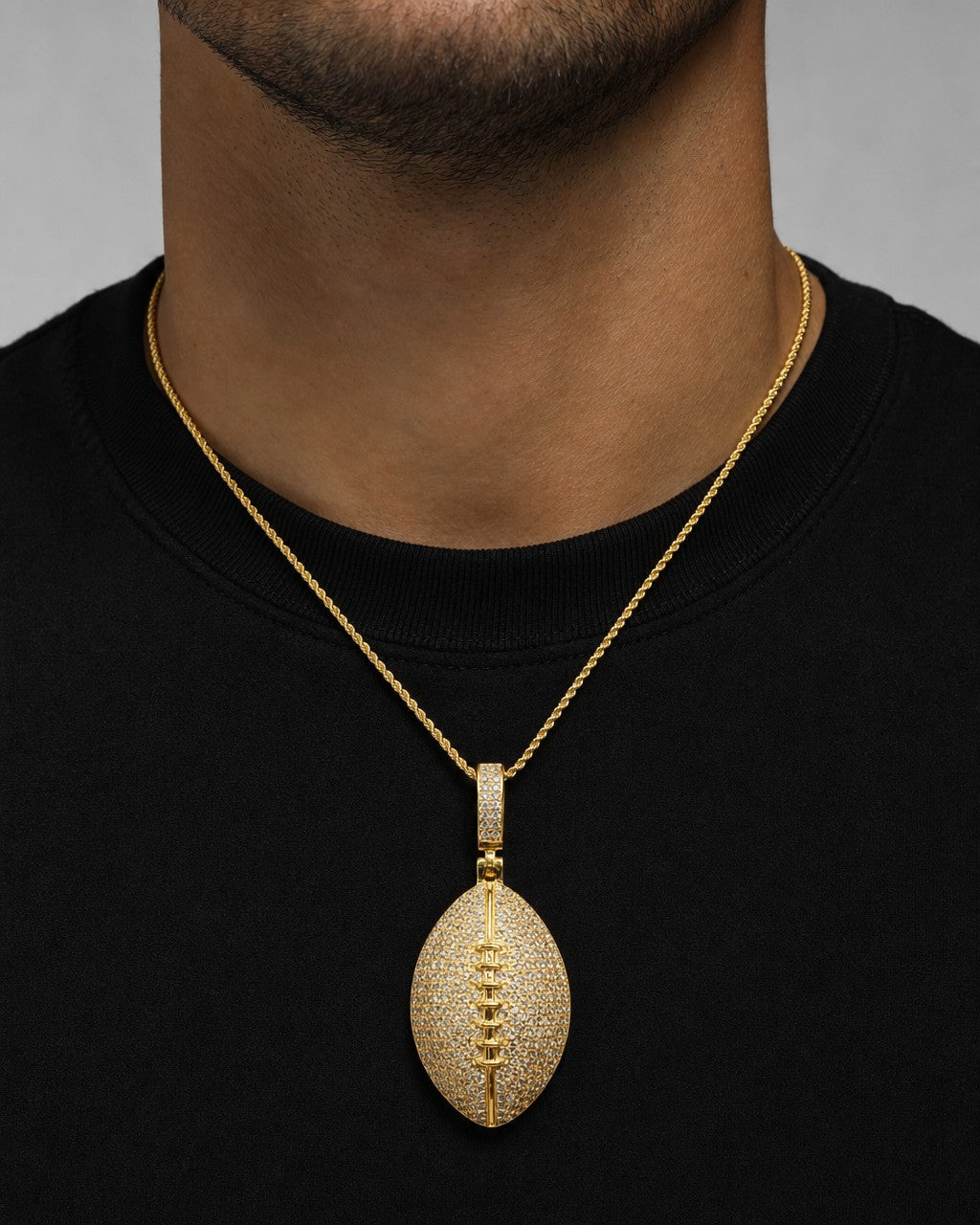 Male model wearing 10K Football Diamond Pendant