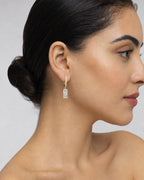 Female model wearing 14K Rococo Diamond Baguette Dangling Earrings