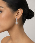 Female model wearing 14K Navette Diamond Dangling Earrings