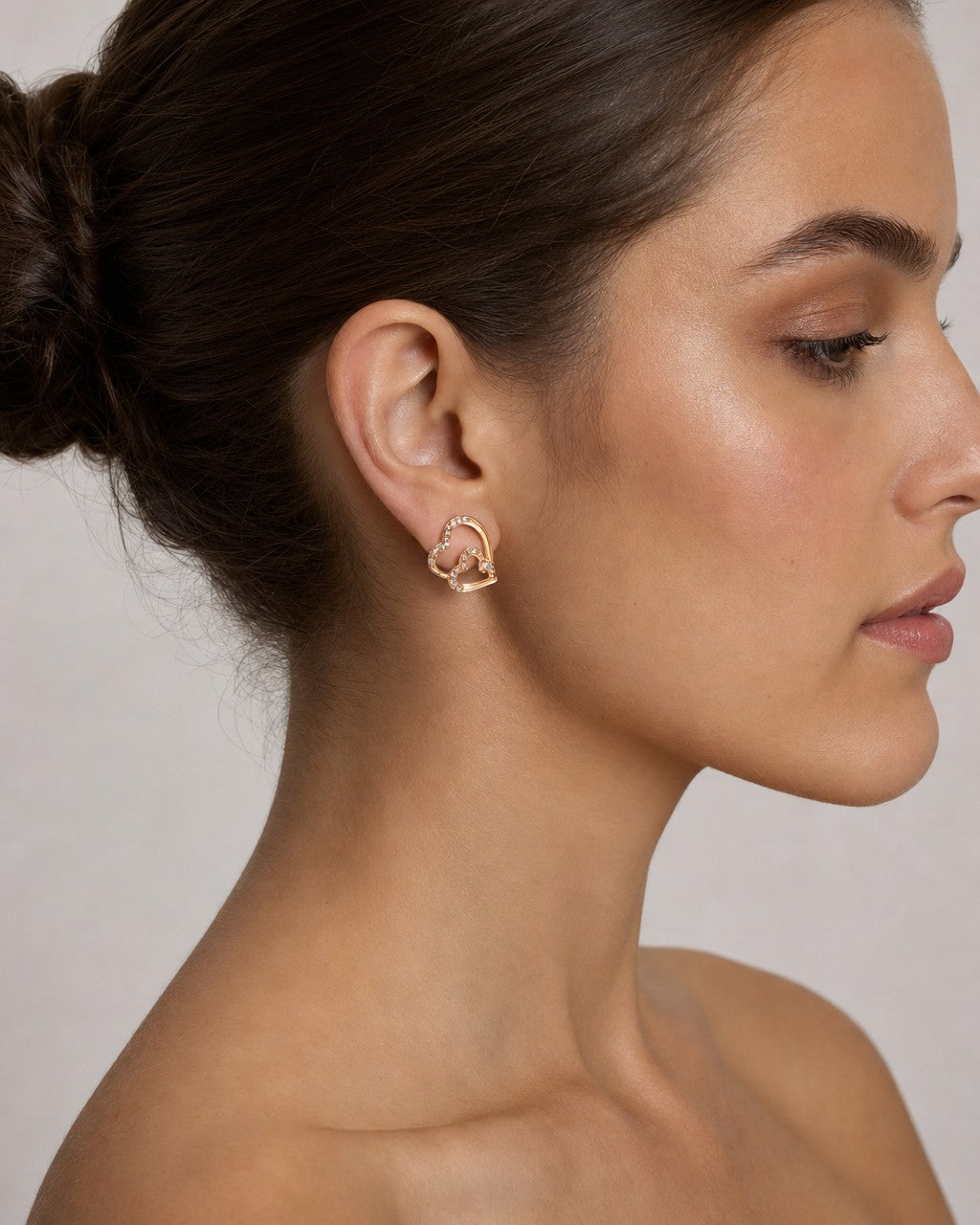 Female model wearing 14K Treasure Heart Diamond Earrings