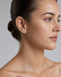 Female model wearing 14K Protect Heart Diamond Earrings