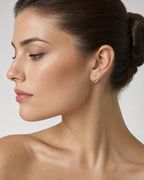 Female model wearing 14K Heart Infinity Diamond Earrings