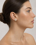 Female model wearing 14K Circle Cake Halo Diamond Baguette Earrings