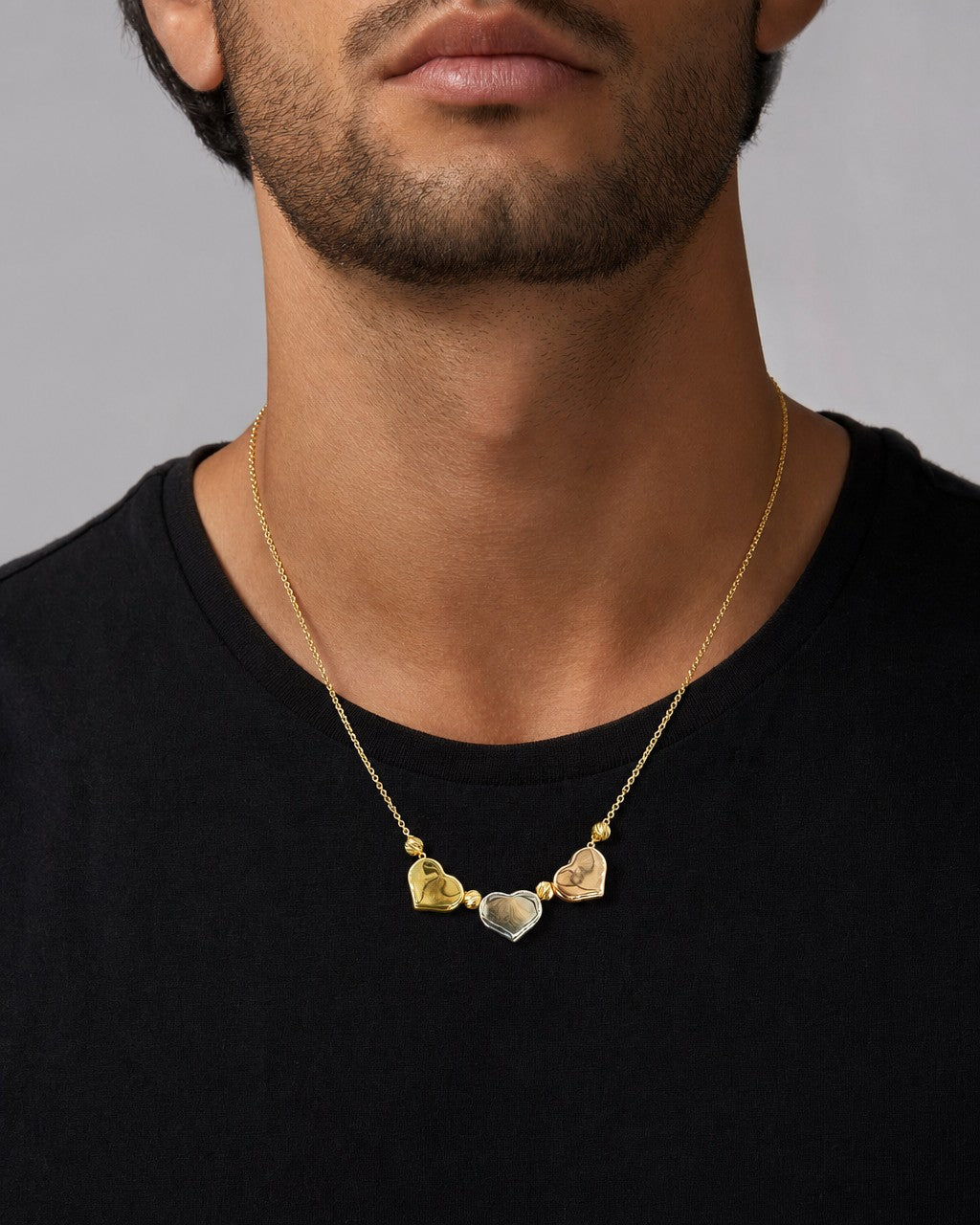 Male model wearing 14K Tri-Color Heart Necklace 18"