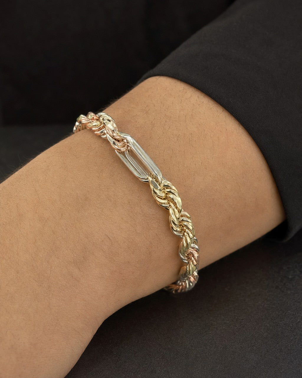 Male model wearing 14K 5.5MM Tri-Color Figaro Rope Link Bracelet 8"