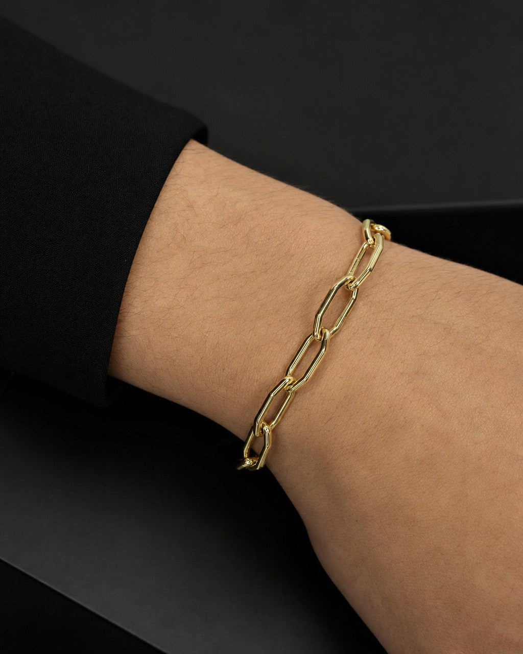Male model wearing 14K Oval Flat Link Bracelet 7"