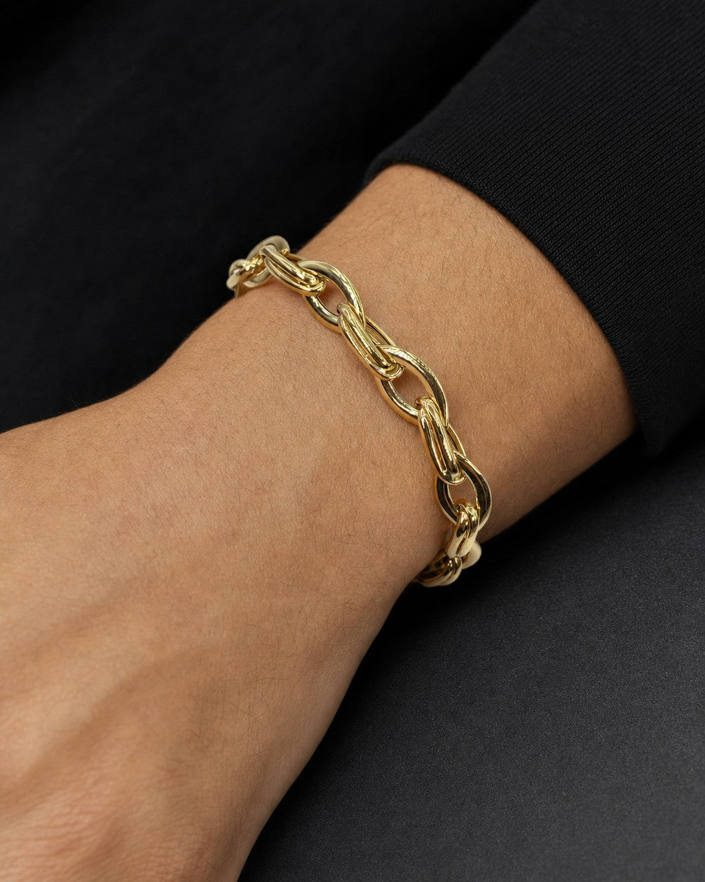 Male model wearing 14K 7.5MM Bold Oval Flat Link Bracelet 7"