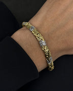 Male model wearing 10K 5.5MM Two-Tone Braided Bracelet 7"