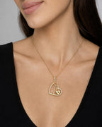 Female model wearing 10K Key & Lock Heart Diamond Pendant
