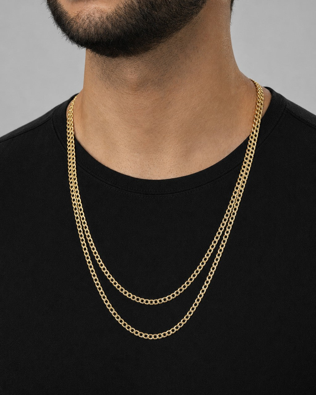 Male model wearing 14K 4.5MM Flat Two-Tone Cuban Link Chain 22-24"