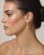 Female model wearing 14K Pave Cross Diamond Hoop Earrings