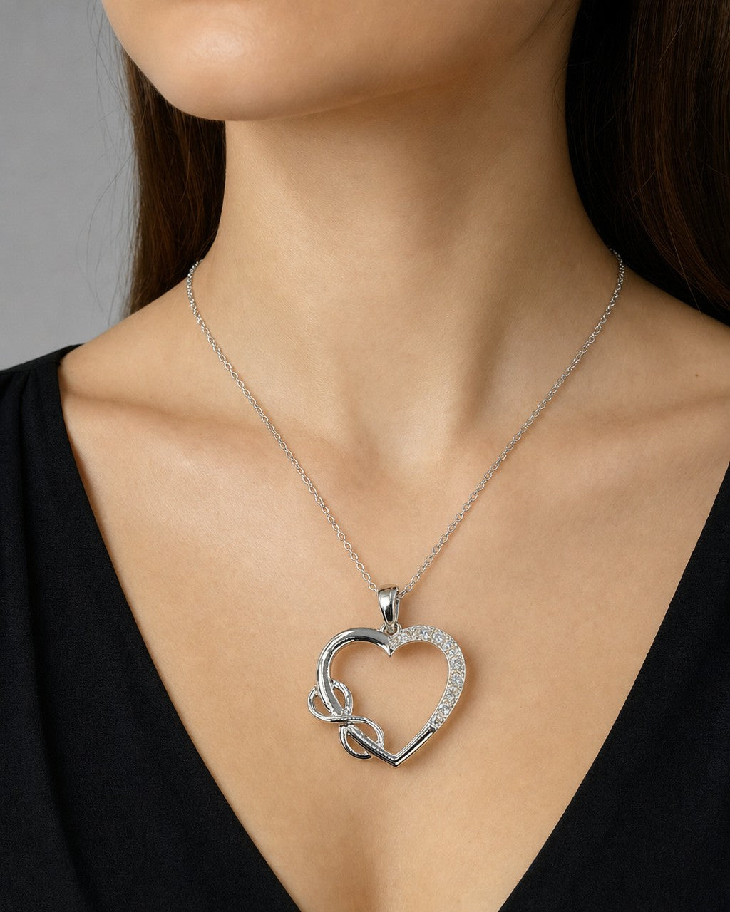 Female model wearing 14K Heart Infinity Diamond Pendant