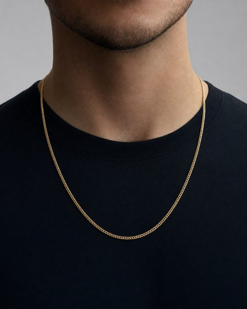 Male model wearing 10K Gold 1.8MM Flat Cuban Link Chain 22"