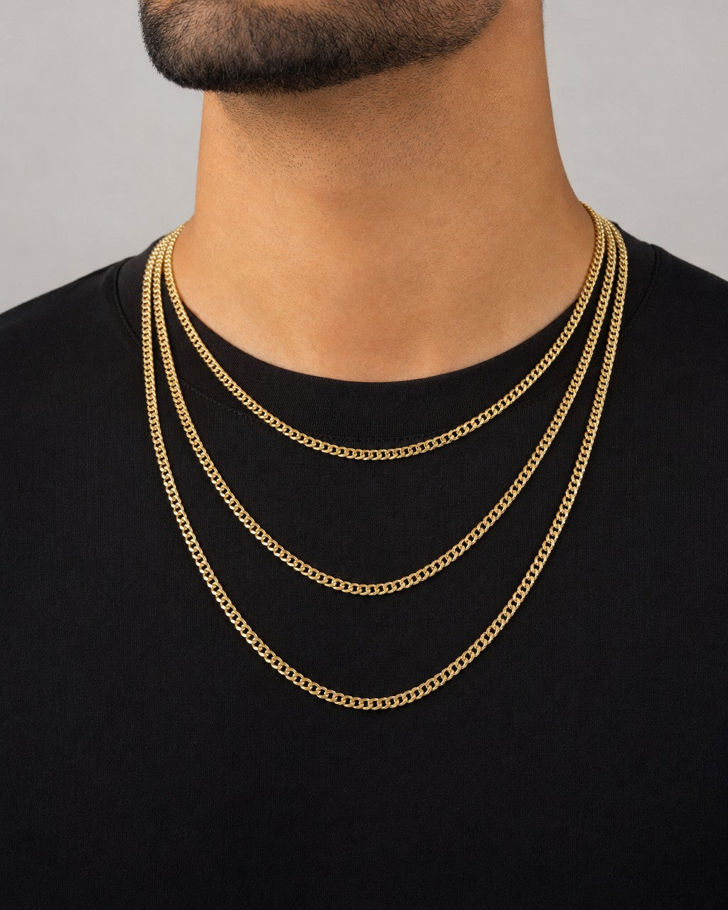 Male model wearing 10K Gold 3MM Flat Cuban Link Chain 16-20"