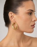 Female model wearing 14K Gold Hoop Earrings 4MM