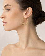 Female model wearing 14K Gold Hoop Earrings 3.5MM