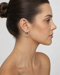 Female model wearing 14K Tube Hoop Earrings