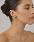 Female model wearing 14K Greek Huggie Hoop Earings