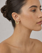 Female model wearing 14K Greek Huggie Hoop Earings