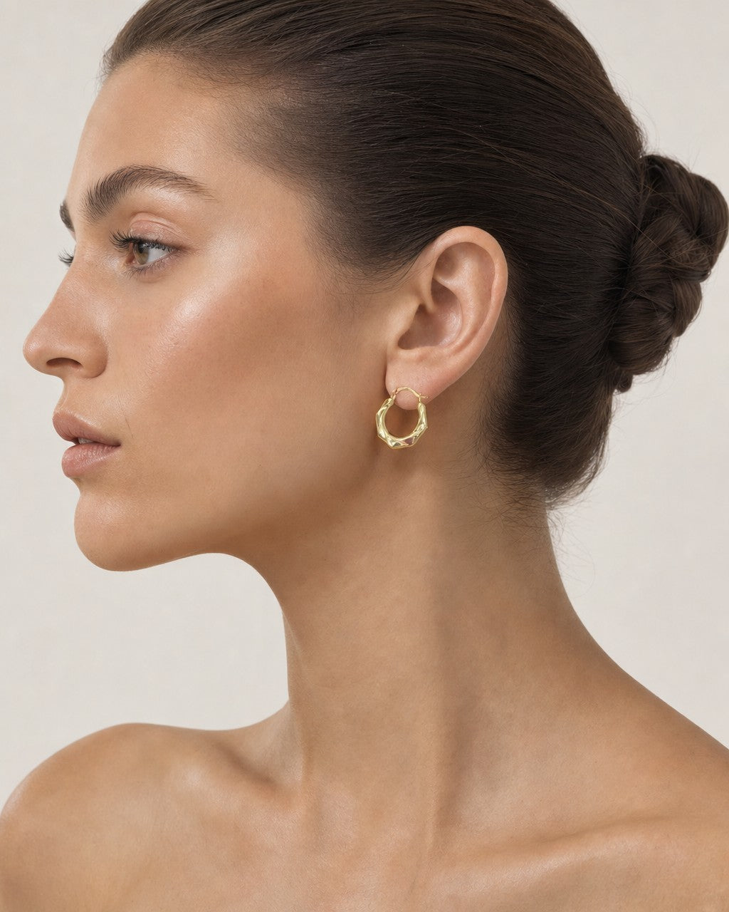 Female model wearing 14K Flat Twist Hoop Earrings