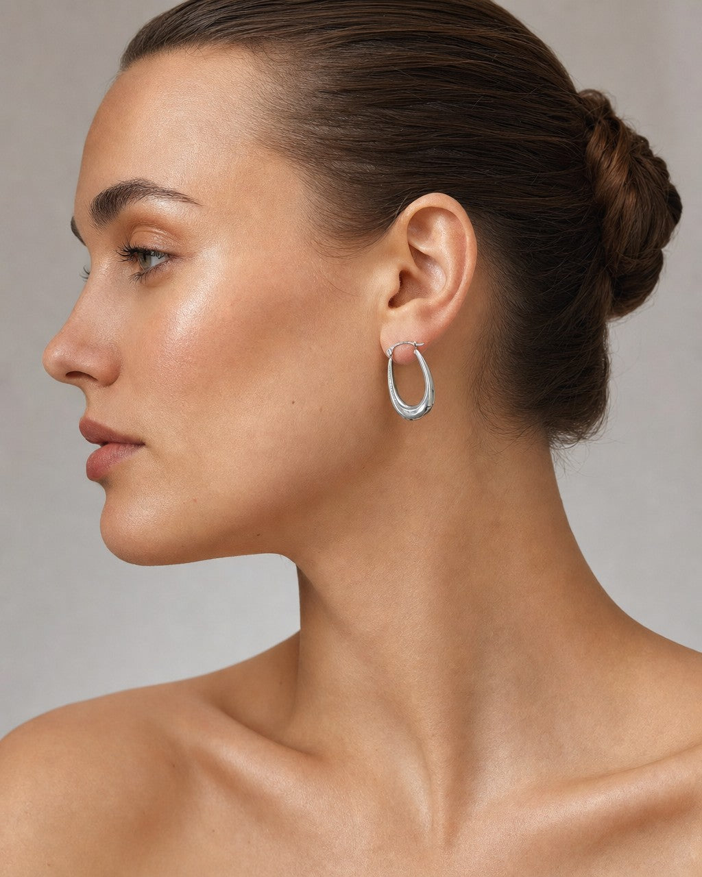 Female model wearing 14K Bold U Hoop Earrings