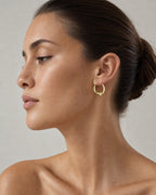 Female model wearing 14K Puff Heart Hoop Earrings