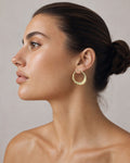 Female model wearing 14K Wave Hoop Earrings