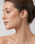 Female model wearing 14K Heartbreaker Hoop Earrings
