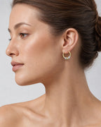 Female model wearing 14K Heartbreaker Hoop Earrings