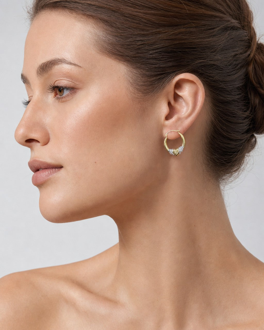Female model wearing 14K Heartbreaker Hoop Earrings