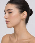 Female model wearing 14K Heart Hoop Earrings