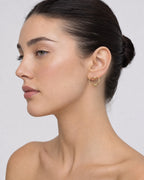 Female model wearing 14K Heart Hoop Earrings