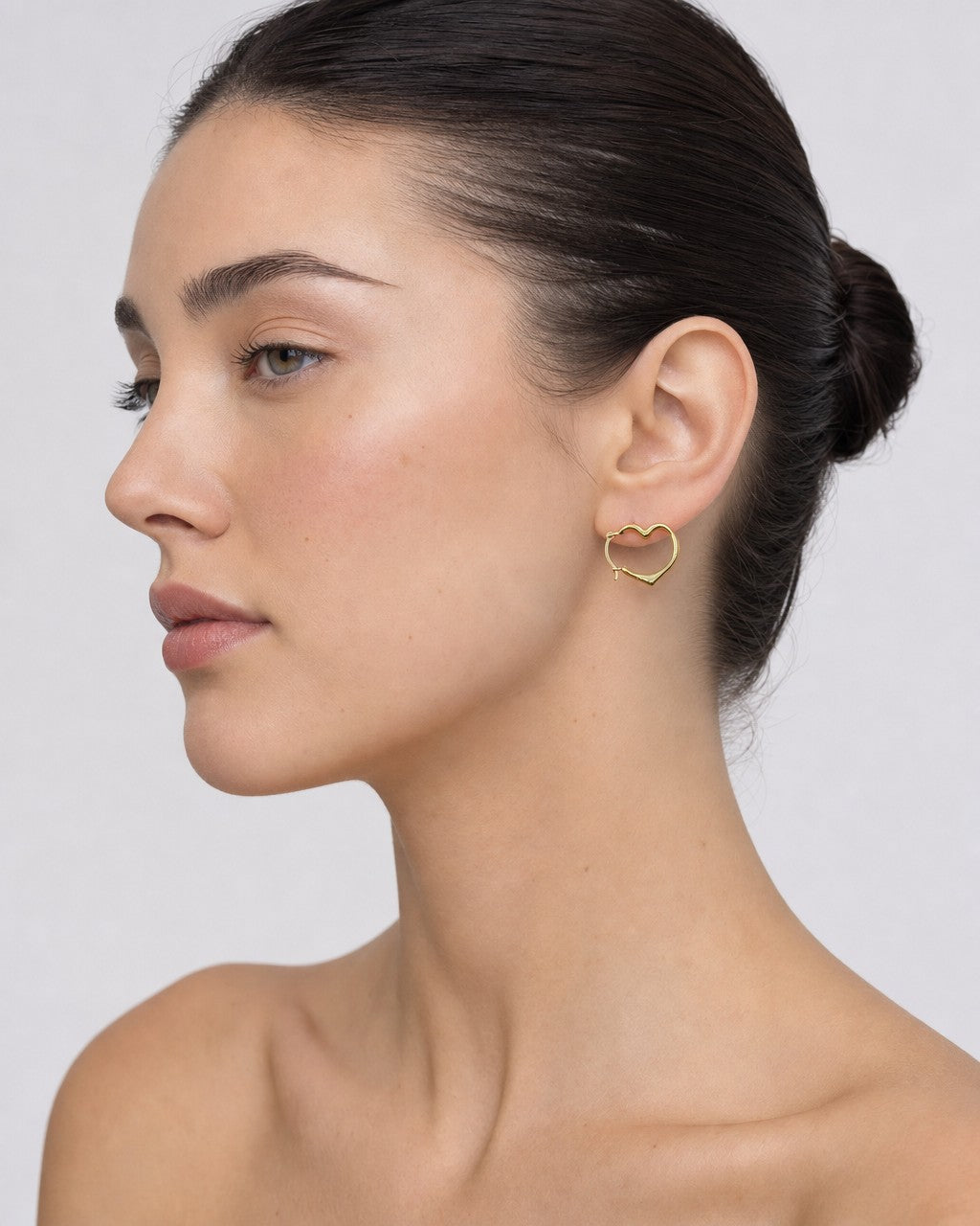 Female model wearing 14K Heart Hoop Earrings