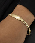 Male model wearing 10K Custom Name Plate Mariner Link Baby Bracelet