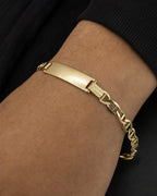 Male model wearing 10K Custom Name Plate Mariner Link Baby Bracelet
