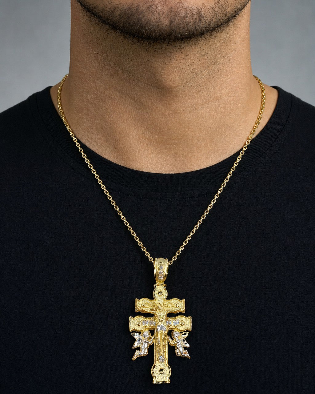 Male model wearing 10K Caravaca Cross Pendant