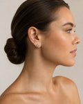 Female model wearing 10K Flower Diamond Baguette Earrings