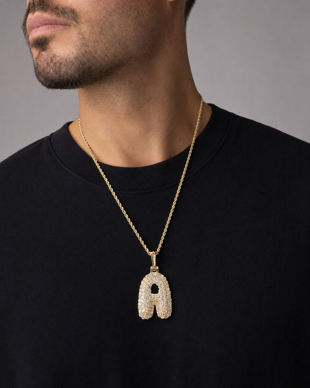 Male model wearing Bubble Initial Letter Diamond Pendant in 14K Full Collection