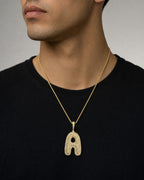 Male model wearing Bubble Initial Letter Diamond Pendant in 10K Full Collection