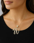 Female model wearing 14K Initial W Script Heart Diamond Pendant