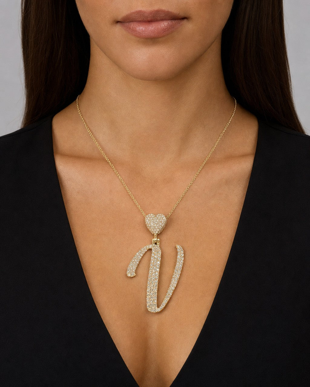 Female model wearing 14K Initial V Script Heart Diamond Pendant