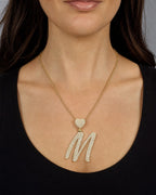 Female model wearing 14K Initial M Script Heart Diamond Pendant